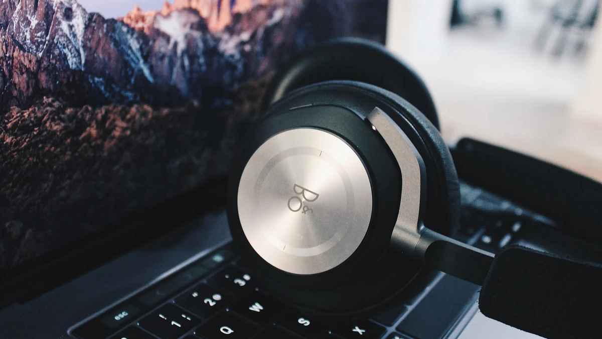 Over-ear headphones resting on a laptop keyboard