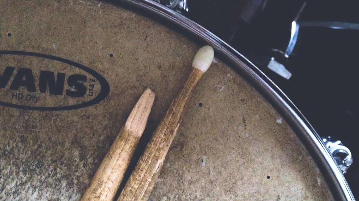 Drumsticks lying on a snare drum head